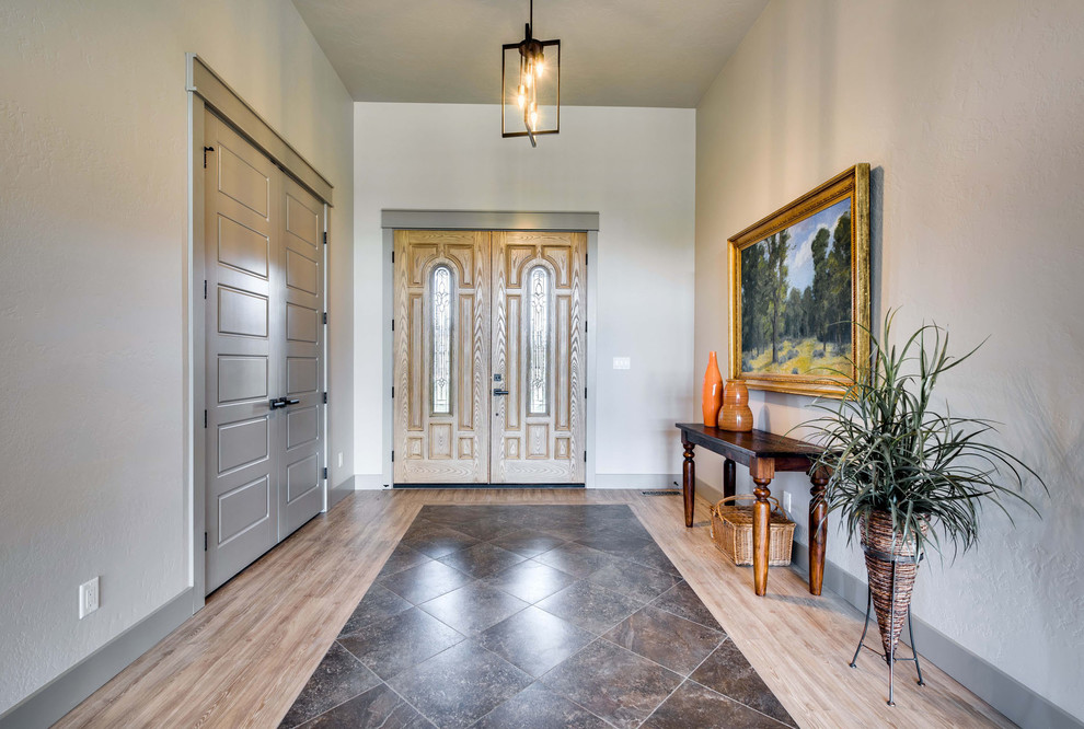 Photo of a large transitional front door in Boise with grey walls, light hardwood floors, a double front door and a light wood front door.