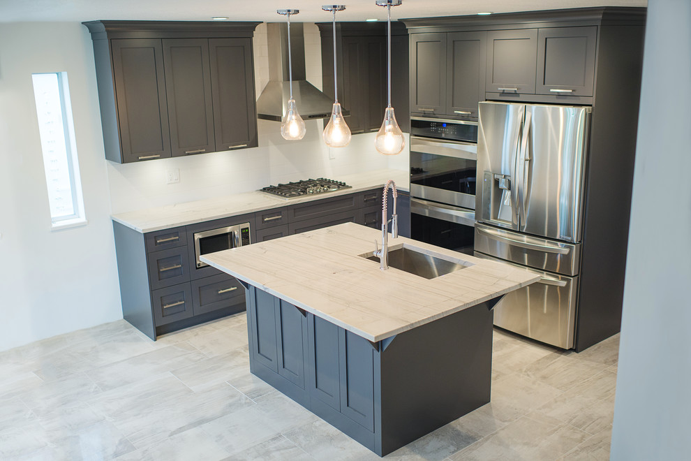 Inspiration for a mid-sized transitional l-shaped eat-in kitchen remodel in Vancouver with a single-bowl sink, shaker cabinets, gray cabinets, marble countertops, white backsplash, stainless steel appliances and an island