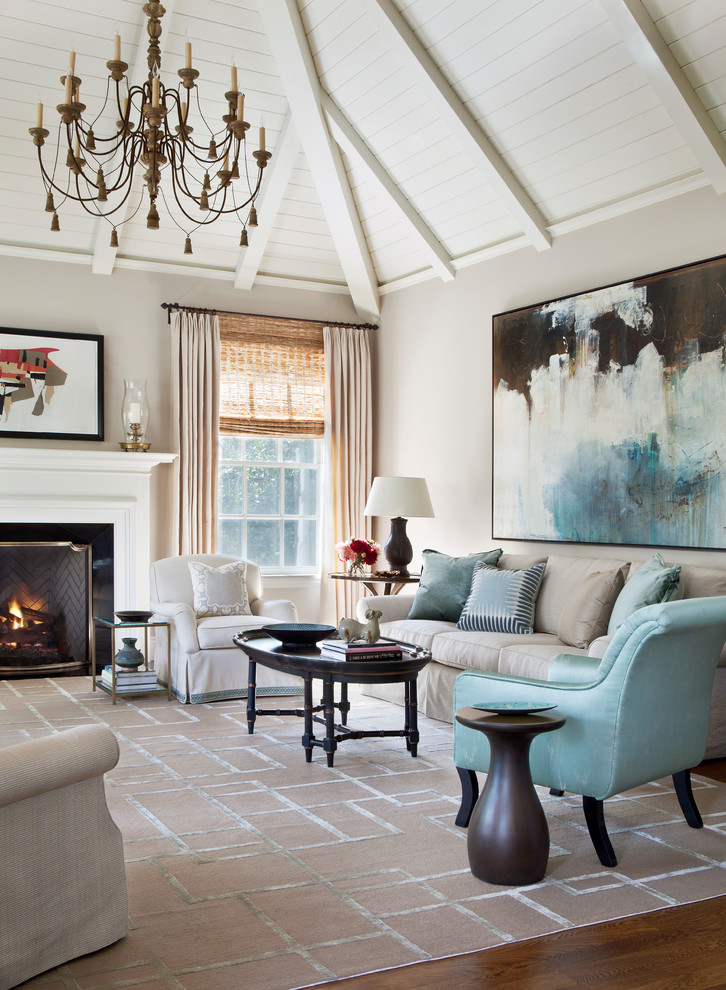 Inspiration for a transitional open concept living room in Los Angeles with beige walls, medium hardwood floors, a standard fireplace, a wood fireplace surround and brown floor.