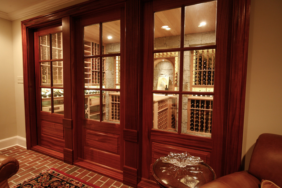 Inspiration for a large traditional wine cellar in Charlotte with travertine floors and storage racks.
