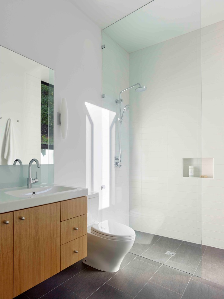 Inspiration for a modern master bathroom in San Francisco with flat-panel cabinets, an alcove shower, a two-piece toilet, subway tile, white walls and a trough sink.