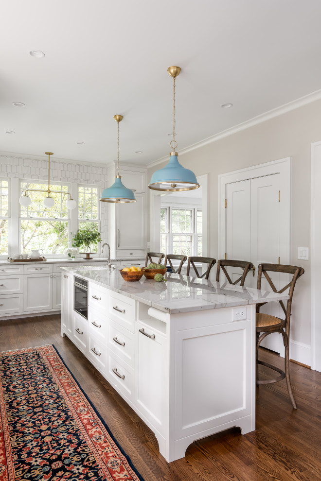 Large beach style galley dark wood floor and brown floor eat-in kitchen photo in Atlanta with an undermount sink, shaker cabinets, white cabinets, quartzite countertops, white backsplash, marble backsplash, paneled appliances, an island and white countertops