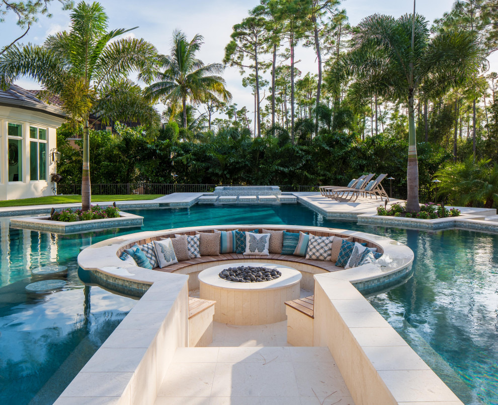 Large transitional backyard custom-shaped natural pool fountain photo in Miami