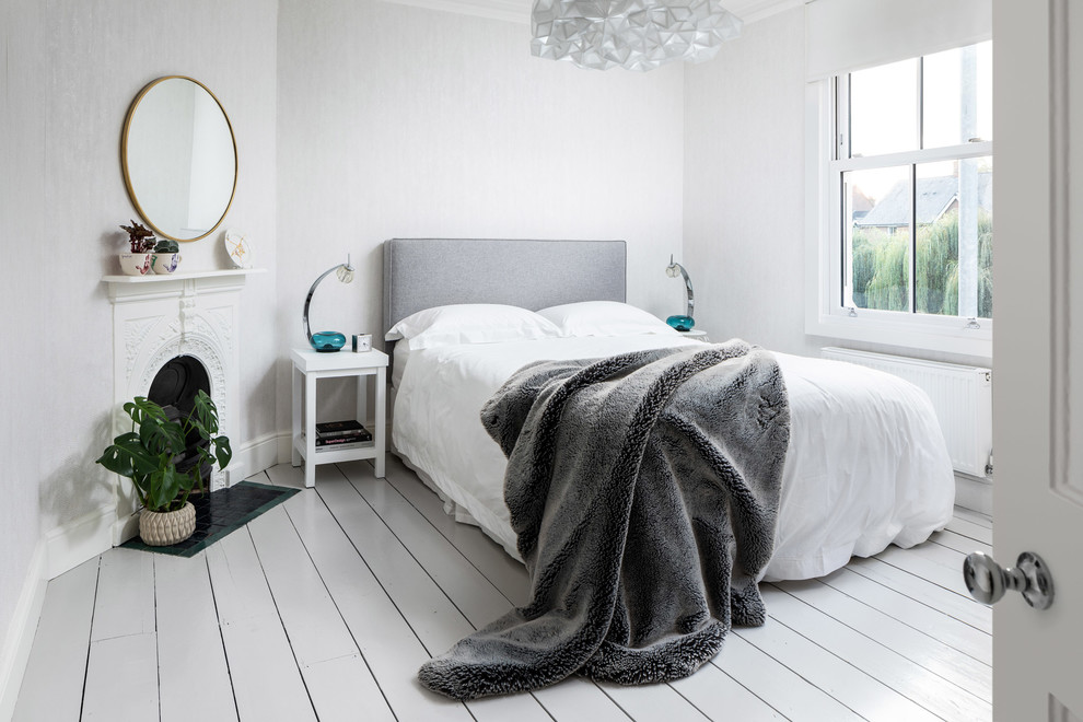 Scandinavian bedroom in Other with grey walls, painted wood floors and white floor.