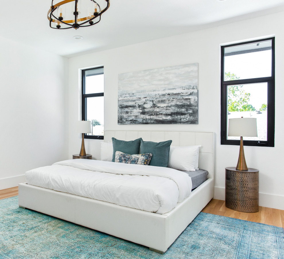 Inspiration for a scandinavian master bedroom in Dallas with white walls, light hardwood floors and no fireplace.