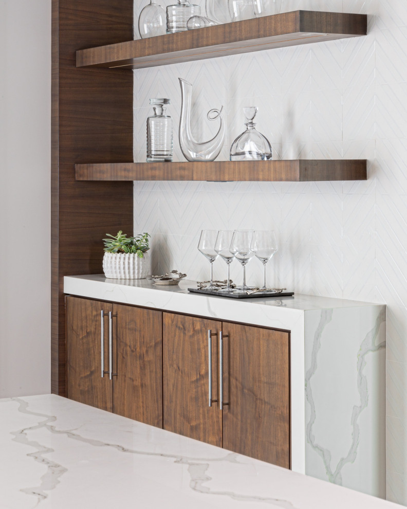 Inspiration for a mid-sized contemporary home bar remodel with flat-panel cabinets, brown cabinets, white backsplash, mosaic tile backsplash and white countertops