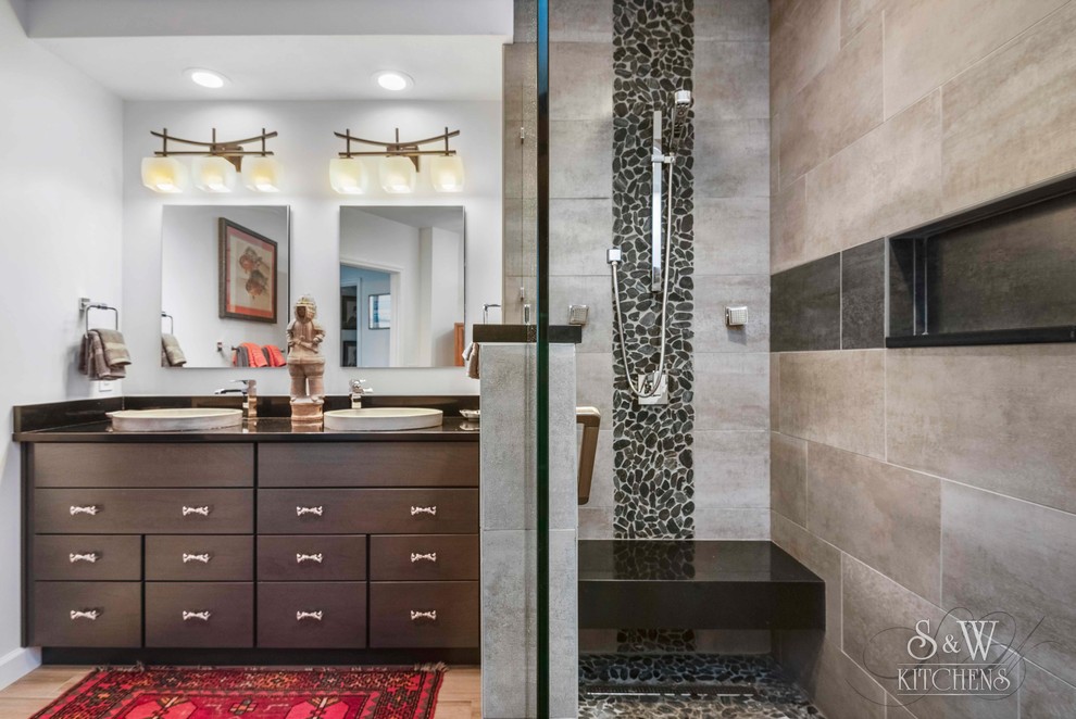 Example of a mid-sized zen master gray tile and porcelain tile porcelain tile and beige floor doorless shower design in Orlando with flat-panel cabinets, gray cabinets, white walls, a drop-in sink, quartz countertops and black countertops