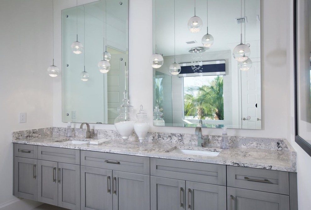 Inspiration for a beach style master bathroom in Austin with shaker cabinets, grey cabinets, a japanese tub, a curbless shower, pink tile, white walls, porcelain floors, an undermount sink and laminate benchtops.