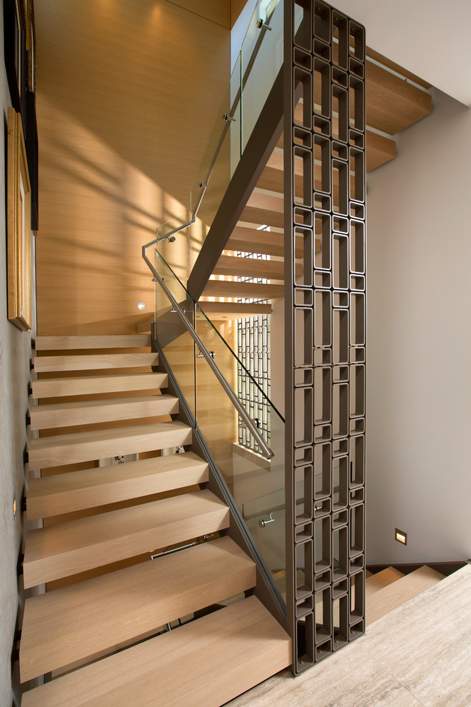 Design ideas for an asian wood u-shaped staircase in Vancouver with open risers and glass railing.