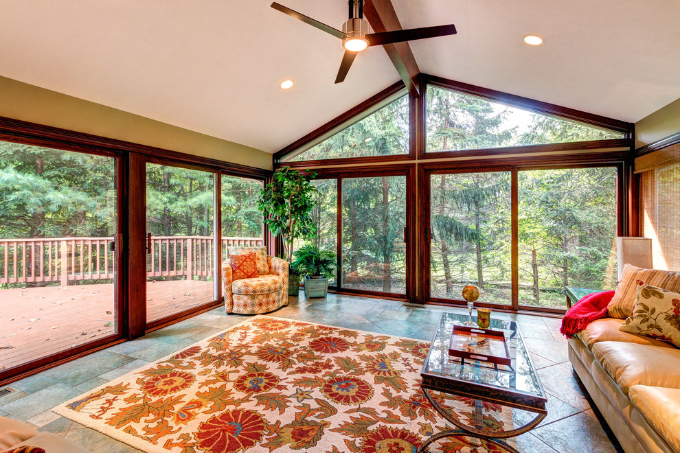 This is an example of a large transitional sunroom in Cleveland with ceramic floors.