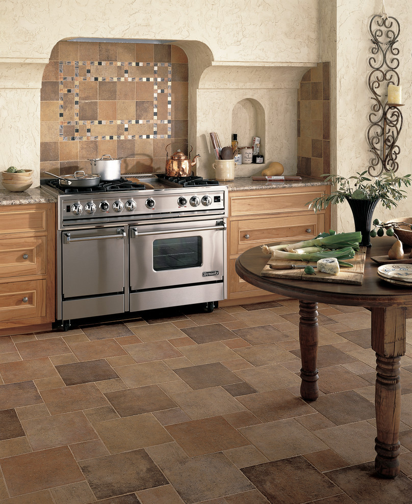 Kitchen - transitional porcelain tile kitchen idea in Miami with medium tone wood cabinets, granite countertops, metallic backsplash, stone tile backsplash and stainless steel appliances