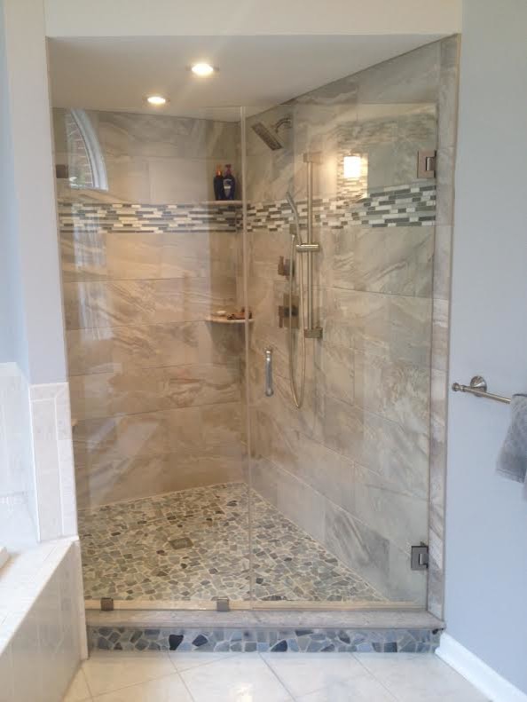 Traditional bathroom in Philadelphia with a corner shower, beige tile and grey walls.