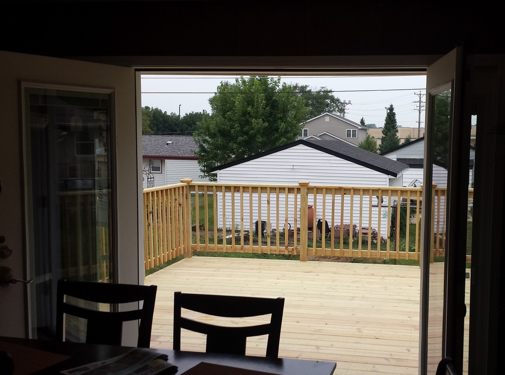 This is an example of a mid-sized arts and crafts backyard deck in Milwaukee with no cover.