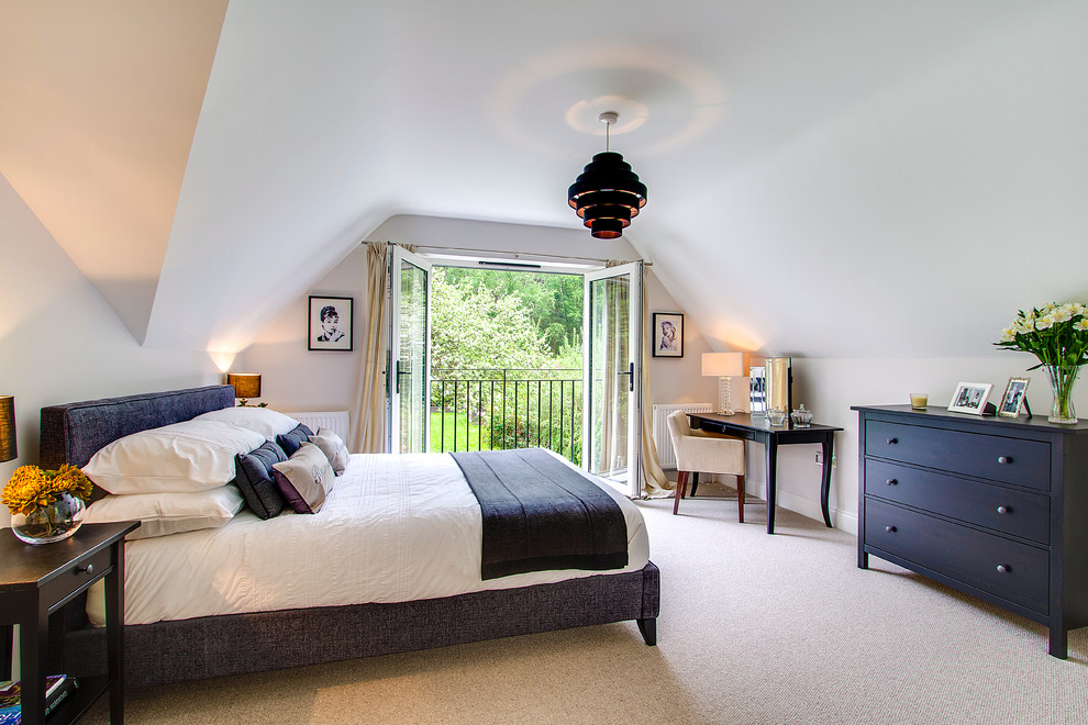 Mid-sized contemporary master bedroom in Surrey with white walls, carpet and beige floor.