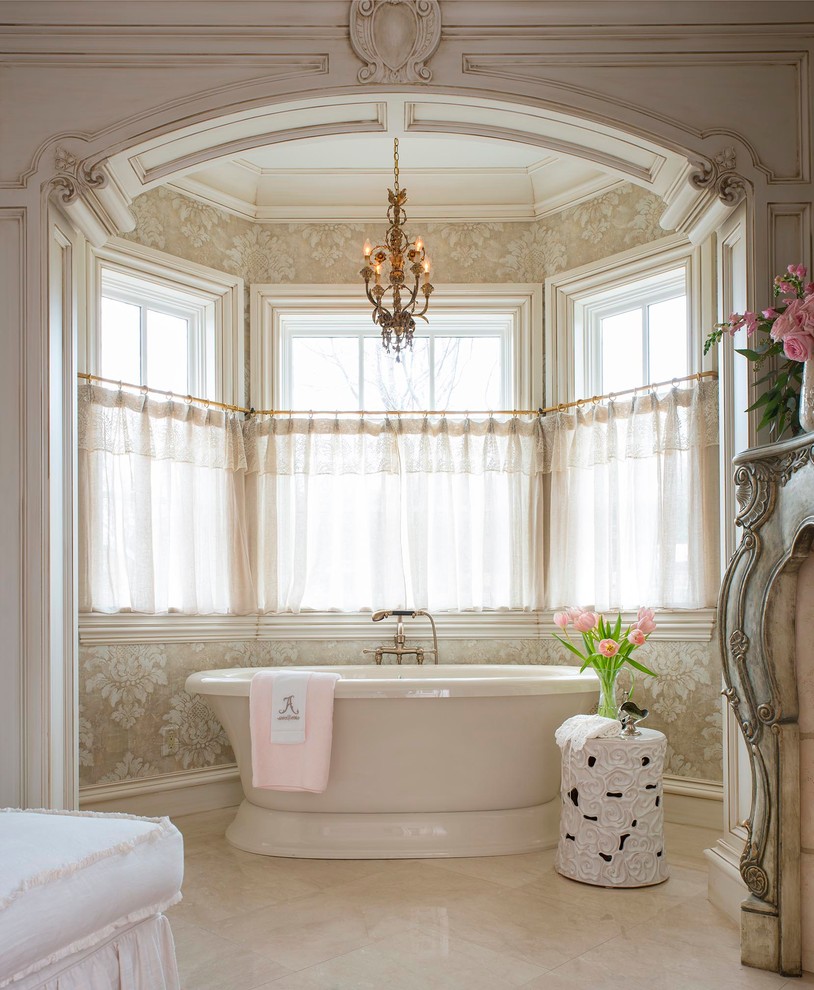 This is an example of a traditional master bathroom in Dallas with a freestanding tub and beige walls.