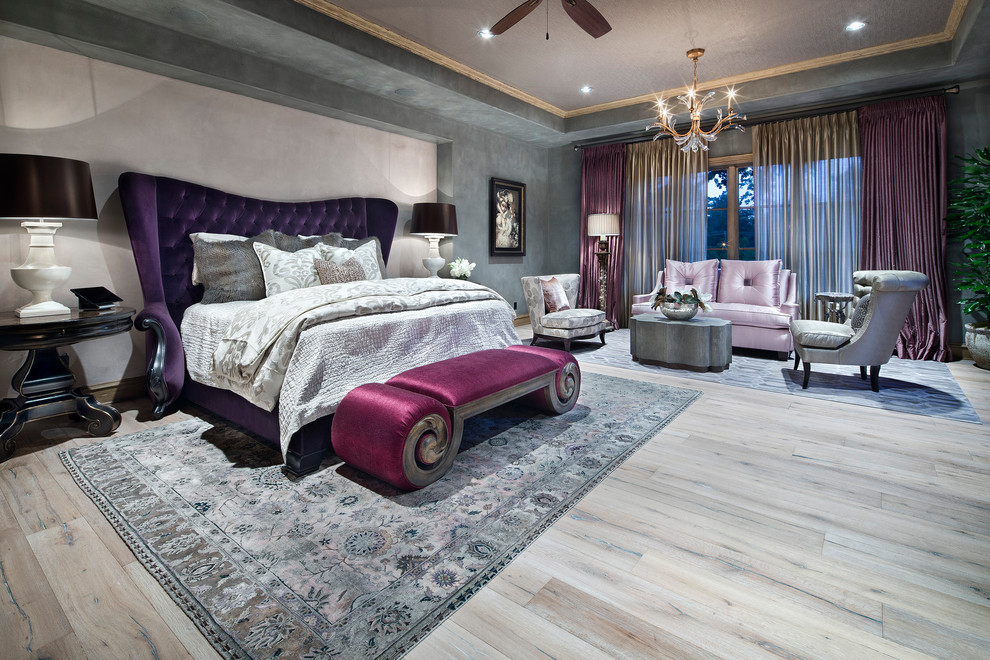 Photo of an expansive mediterranean master bedroom in Houston with multi-coloured walls, beige floor and light hardwood floors.