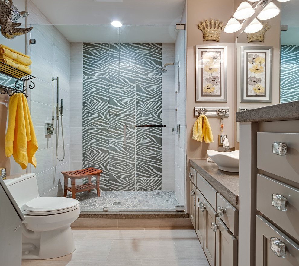 Inspiration for a large eclectic master bathroom in Minneapolis with beaded inset cabinets, grey cabinets, a corner shower, a one-piece toilet, porcelain tile, beige walls, porcelain floors, a vessel sink and solid surface benchtops.