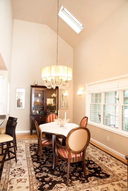 Kitchen/dining room combo - mid-sized transitional light wood floor kitchen/dining room combo idea in Charlotte with beige walls and no fireplace