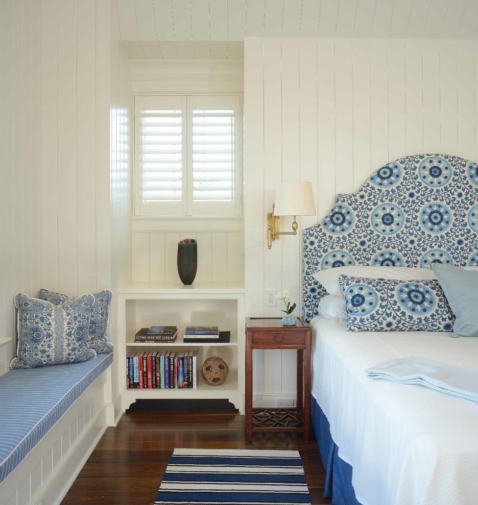 Photo of a large beach style guest bedroom in Charleston with white walls and dark hardwood floors.