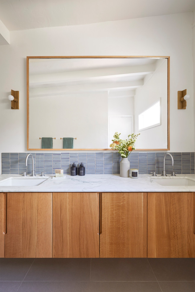 Medium sized midcentury ensuite bathroom in San Francisco with flat-panel cabinets, brown cabinets, an alcove shower, a two-piece toilet, grey tiles, ceramic tiles, white walls, porcelain flooring, a submerged sink, marble worktops, grey floors, an open shower, white worktops, a wall niche, double sinks, a floating vanity unit and exposed beams.