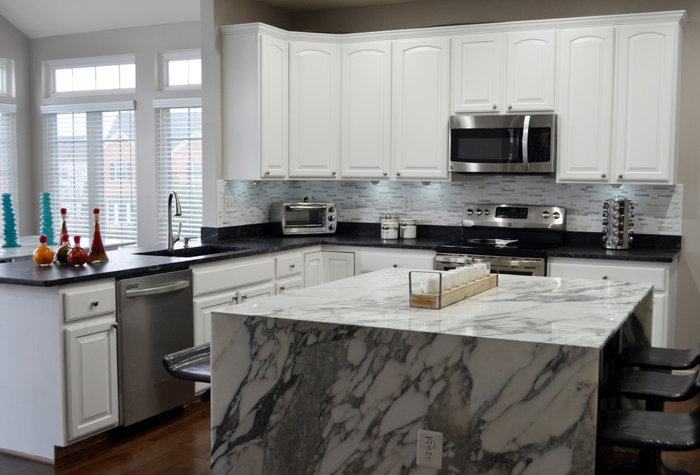 Open concept kitchen - large contemporary l-shaped medium tone wood floor and brown floor open concept kitchen idea in DC Metro with a double-bowl sink, raised-panel cabinets, white cabinets, marble countertops, yellow backsplash, stone tile backsplash, stainless steel appliances and an island