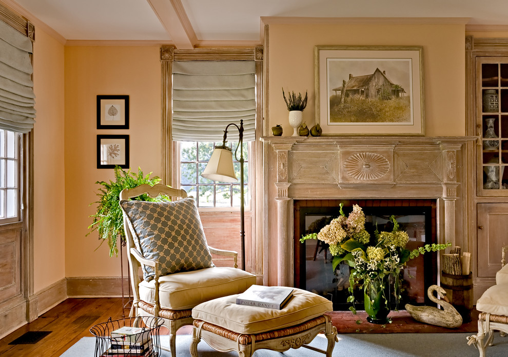 Traditional living room in New York with medium hardwood floors and a standard fireplace.