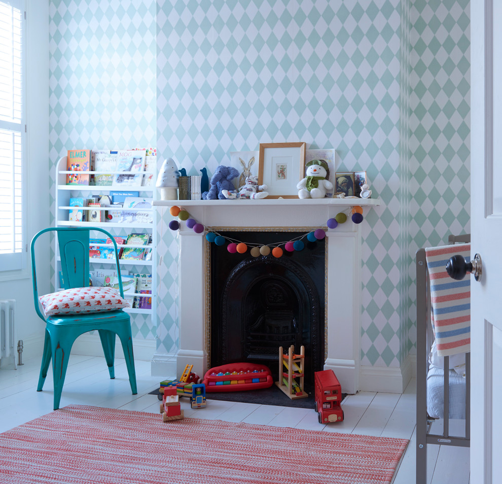 Inspiration for a mid-sized transitional gender-neutral nursery in London with multi-coloured walls, light hardwood floors and white floor.