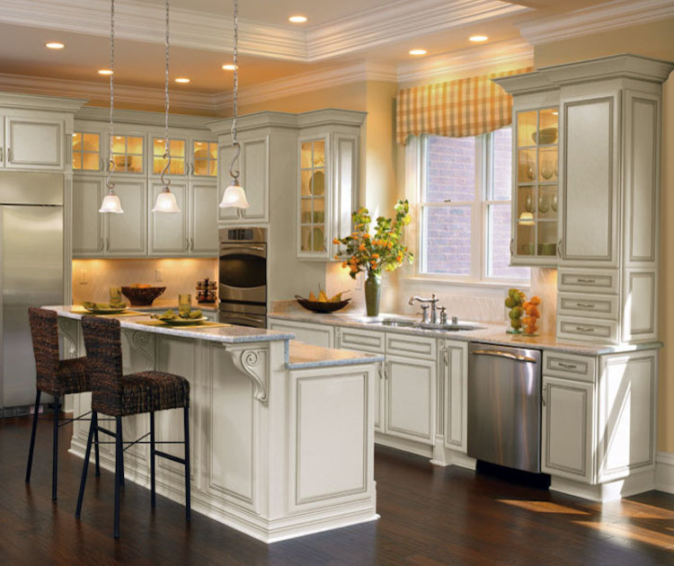 Eat-in kitchen - mid-sized transitional l-shaped dark wood floor and brown floor eat-in kitchen idea in Orange County with an undermount sink, raised-panel cabinets, white cabinets, granite countertops, white backsplash, ceramic backsplash, stainless steel appliances and an island