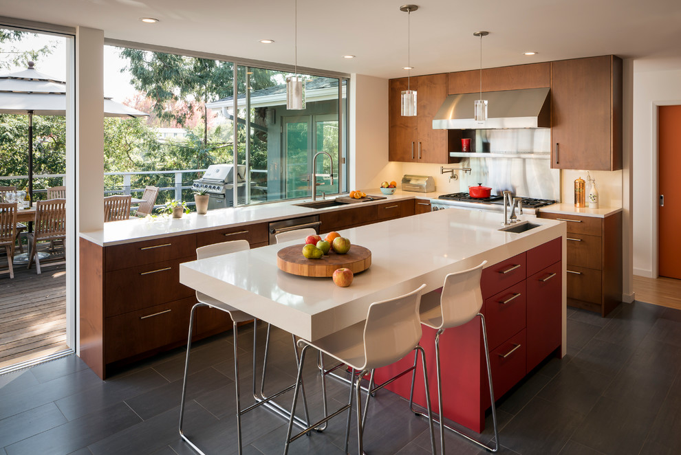 This is an example of a mid-sized contemporary u-shaped kitchen in San Francisco with an undermount sink, flat-panel cabinets, medium wood cabinets, stainless steel appliances, quartz benchtops, white splashback, porcelain floors, with island and grey floor.