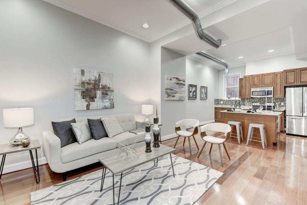 Inspiration for a small modern open concept light wood floor and beige floor family room remodel in DC Metro with gray walls, no fireplace and no tv