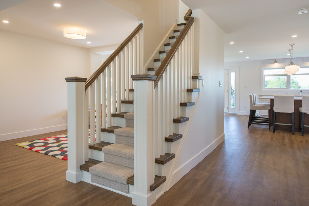 Photo of a mid-sized contemporary wood straight staircase in Toronto with wood railing and painted wood risers.