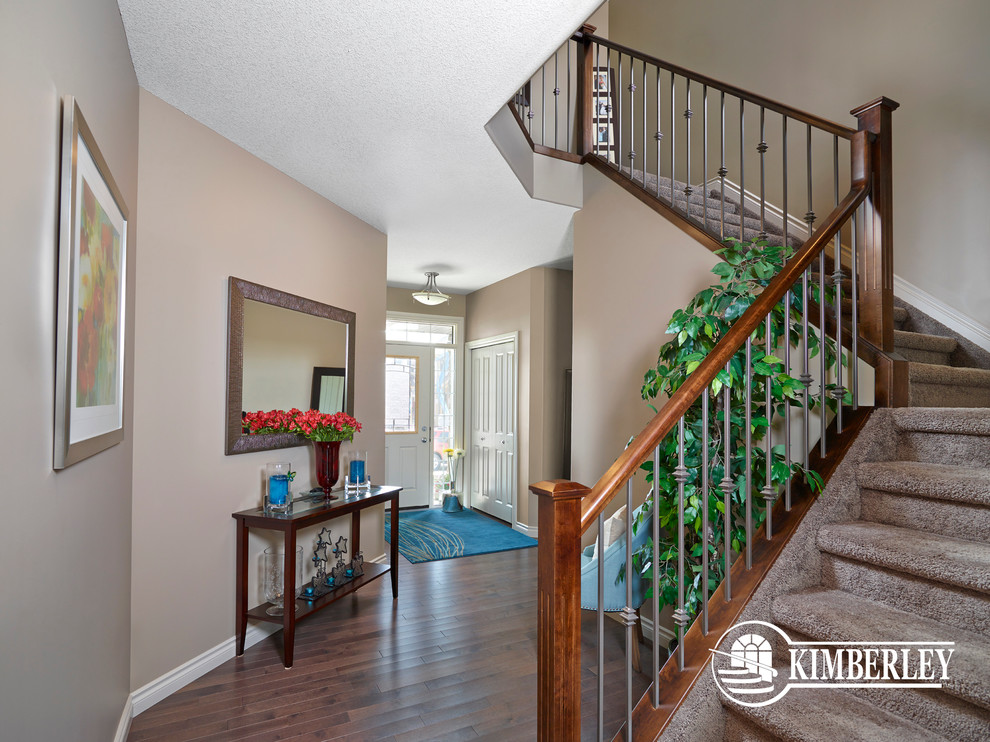 Hallway - transitional medium tone wood floor hallway idea in Edmonton with beige walls