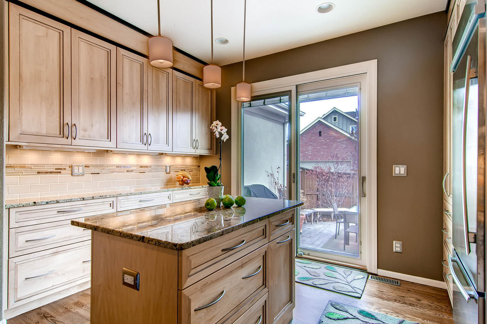 Kitchen pantry - mid-sized transitional u-shaped dark wood floor kitchen pantry idea in Denver with an undermount sink, flat-panel cabinets, light wood cabinets, granite countertops, beige backsplash, glass tile backsplash, stainless steel appliances and an island