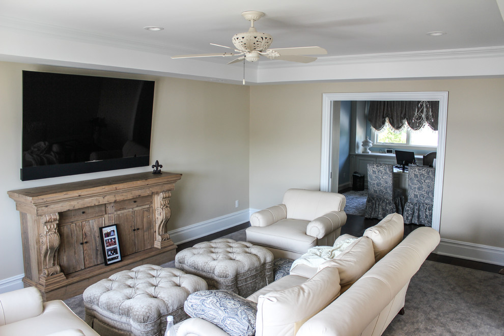 This is an example of a mid-sized traditional open concept family room in New York with beige walls, a game room, dark hardwood floors, no fireplace and a wall-mounted tv.