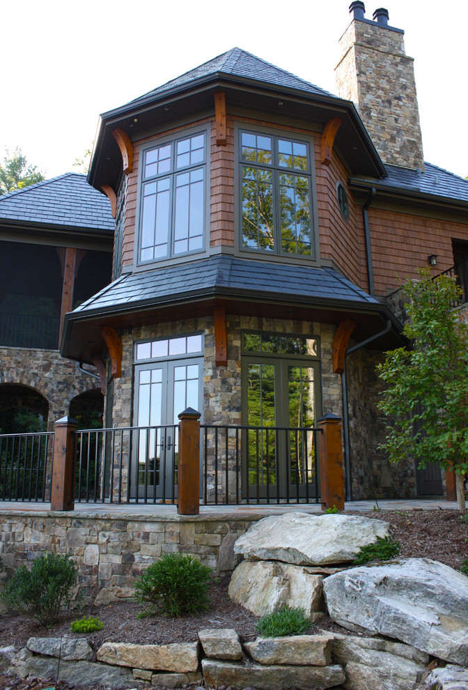 Inspiration for a mid-sized arts and crafts two-storey brown exterior in Other with wood siding and a gable roof.