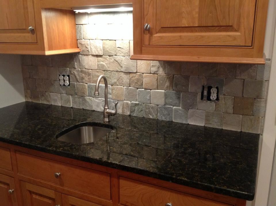 Inspiration for a single-wall open concept kitchen remodel with an integrated sink, raised-panel cabinets, light wood cabinets, granite countertops, multicolored backsplash and stone tile backsplash