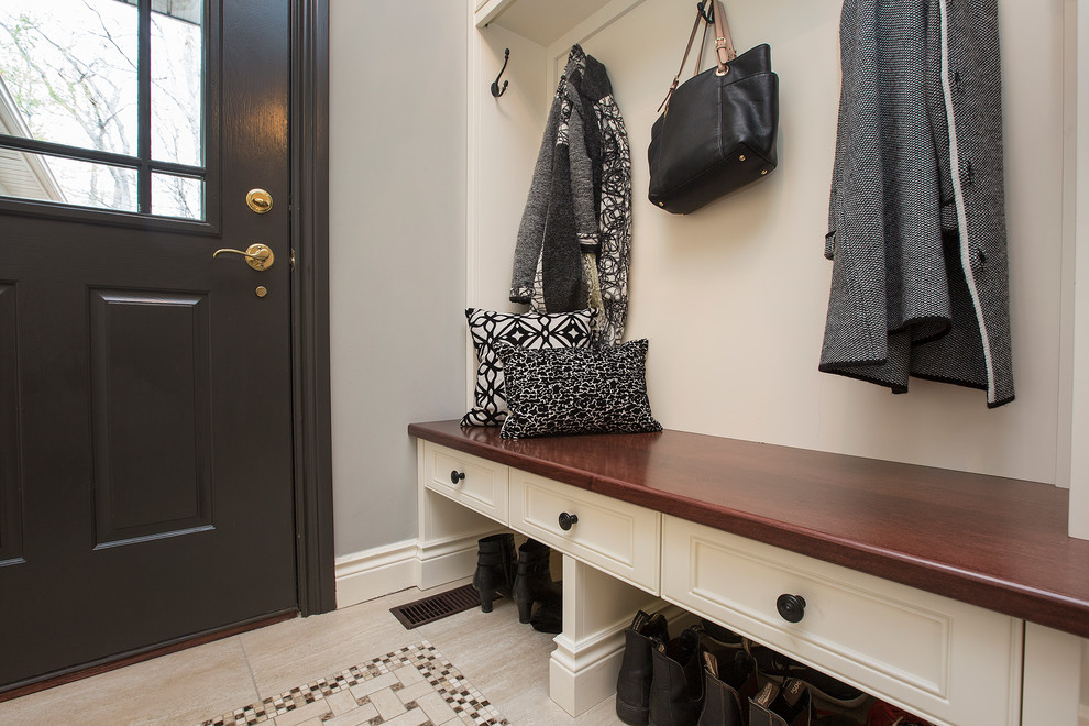Photo of a mid-sized transitional mudroom in Toronto with grey walls, ceramic floors, a single front door and a black front door.
