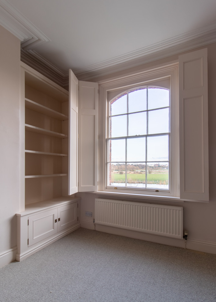 Photo of a mid-sized traditional home office in Cheshire with beige walls, carpet and beige floor.