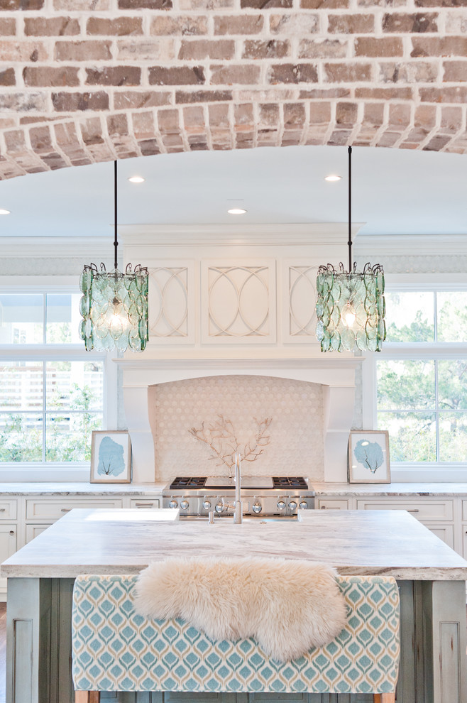 Inspiration for a large beach style u-shaped eat-in kitchen in Jacksonville with a farmhouse sink, beaded inset cabinets, white cabinets, marble benchtops, white splashback, glass sheet splashback, panelled appliances, dark hardwood floors and with island.