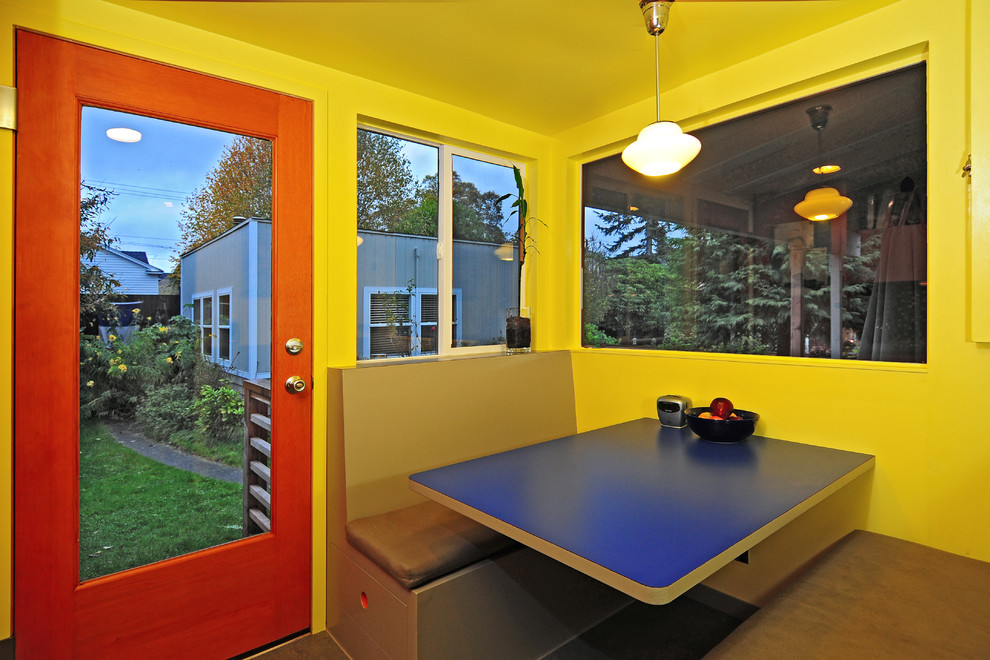 Inspiration for a mid-sized transitional galley linoleum floor eat-in kitchen remodel in Seattle with a single-bowl sink, flat-panel cabinets, medium tone wood cabinets, laminate countertops, blue backsplash, mosaic tile backsplash, black appliances, yellow walls and no island