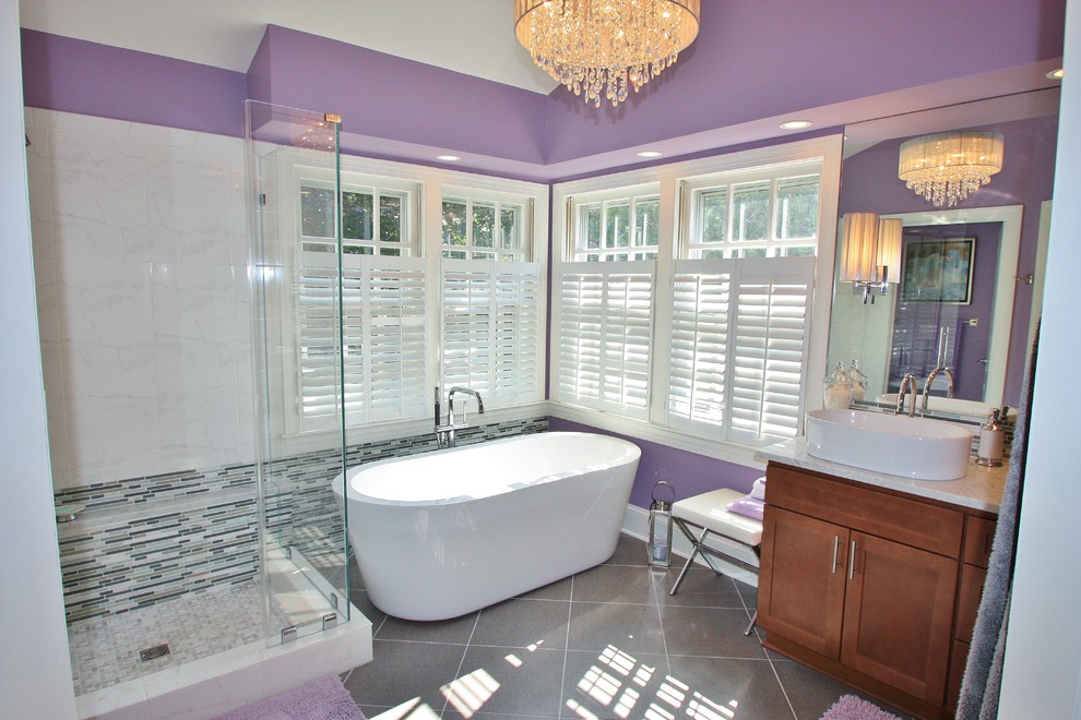 This is an example of a contemporary bathroom in DC Metro with a vessel sink, a freestanding tub and purple walls.