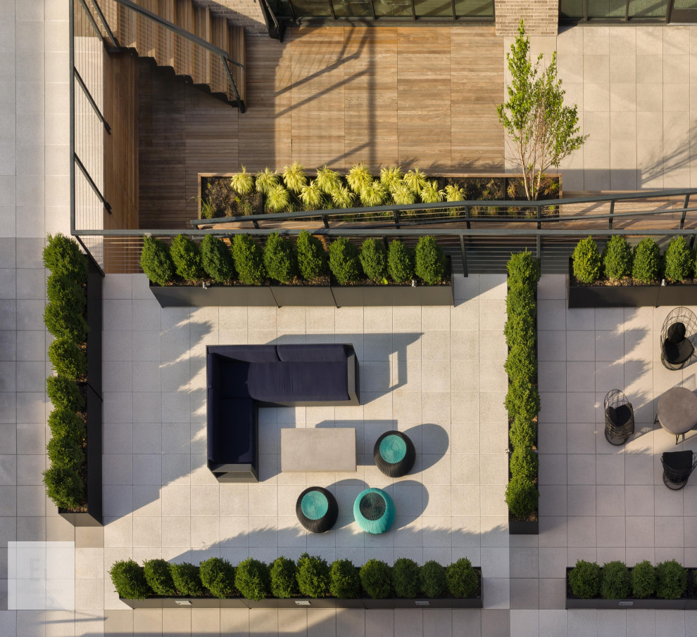 Photo of an expansive contemporary rooftop deck in New York with a container garden and a pergola.