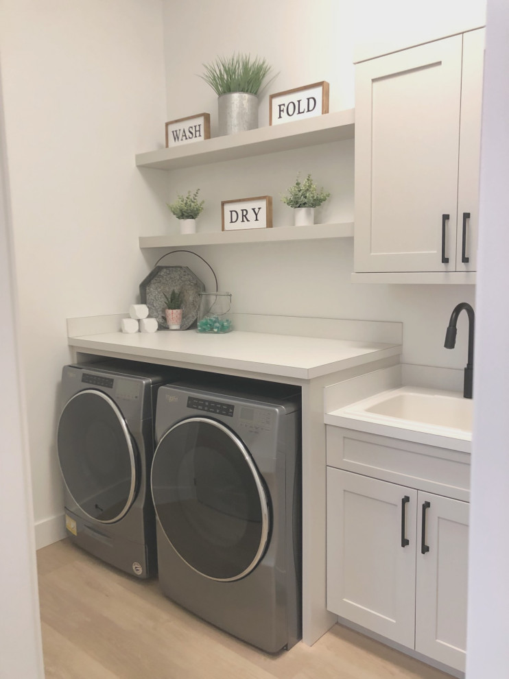 Inspiration for a large modern single-wall separated utility room in Other with a built-in sink, shaker cabinets, grey cabinets, laminate countertops, a side by side washer and dryer and white worktops.