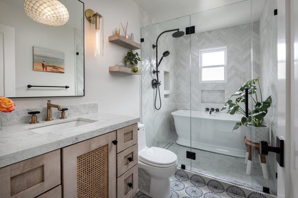 Transitional multicolored floor and single-sink freestanding bathtub photo in Los Angeles with an undermount sink, shaker cabinets, light wood cabinets, white walls and gray countertops