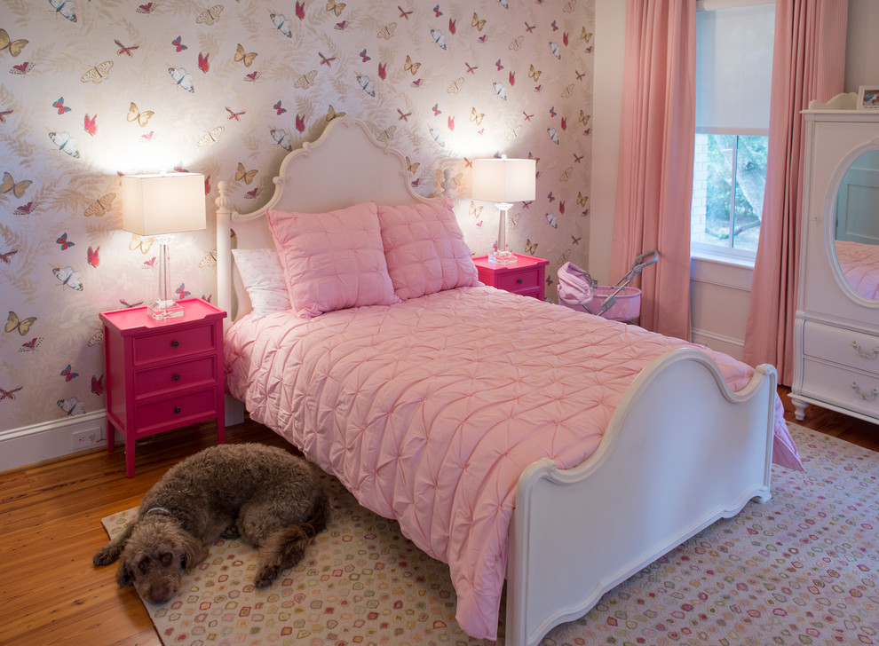 Design ideas for a mid-sized traditional kids' bedroom for kids 4-10 years old and girls in Charleston with pink walls, medium hardwood floors and brown floor.