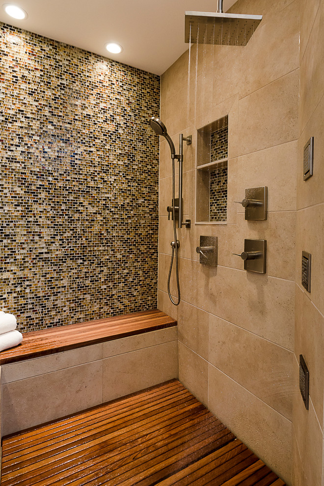 This is an example of a large contemporary master bathroom in Chicago with multi-coloured tile, beige walls, medium hardwood floors, an alcove shower, mosaic tile, a niche and a shower seat.
