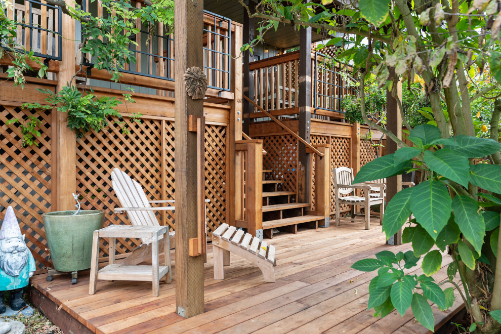 Example of a large mountain style backyard ground level wood railing deck design in San Francisco with no cover