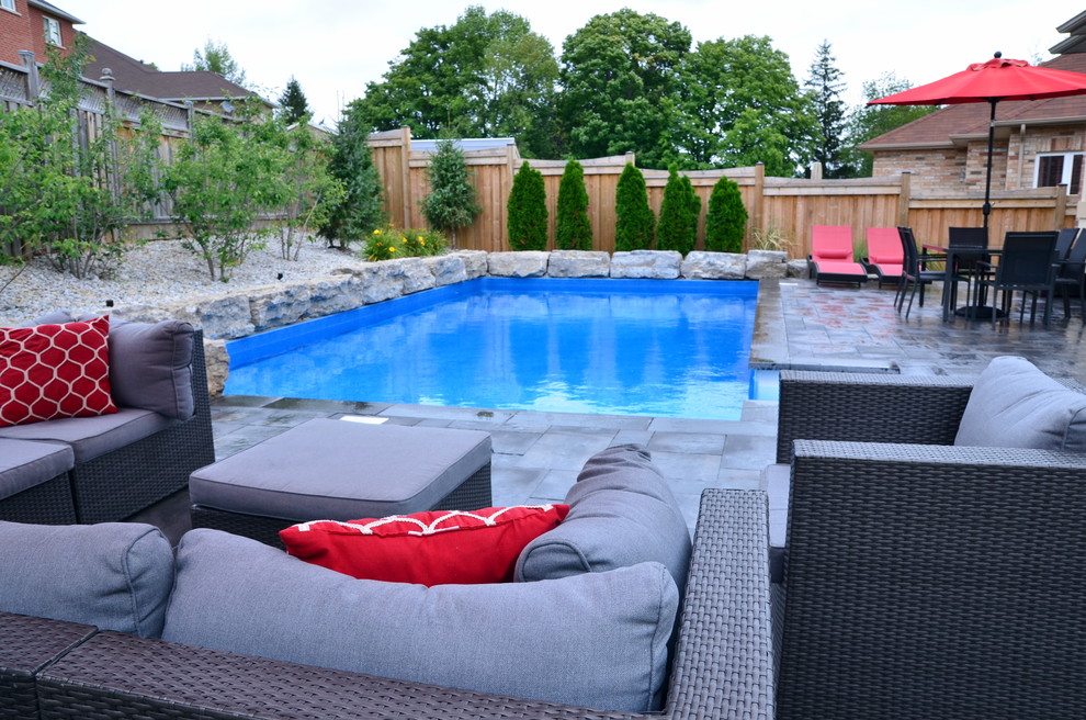 Design ideas for a contemporary rectangular pool in Toronto with concrete pavers.
