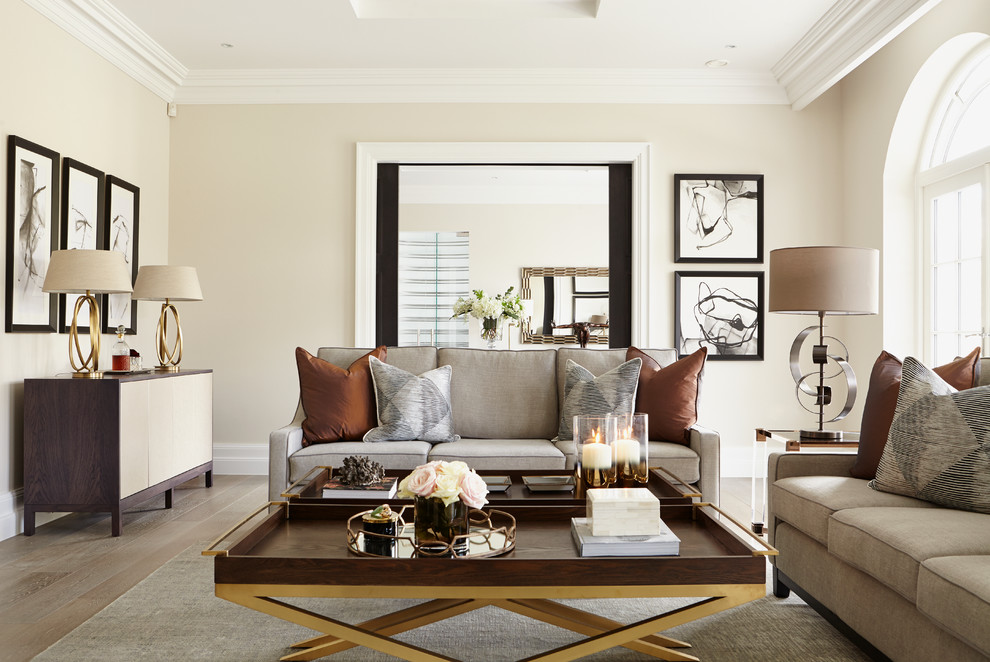 Design ideas for a contemporary living room in London with beige walls, light hardwood floors and no fireplace.