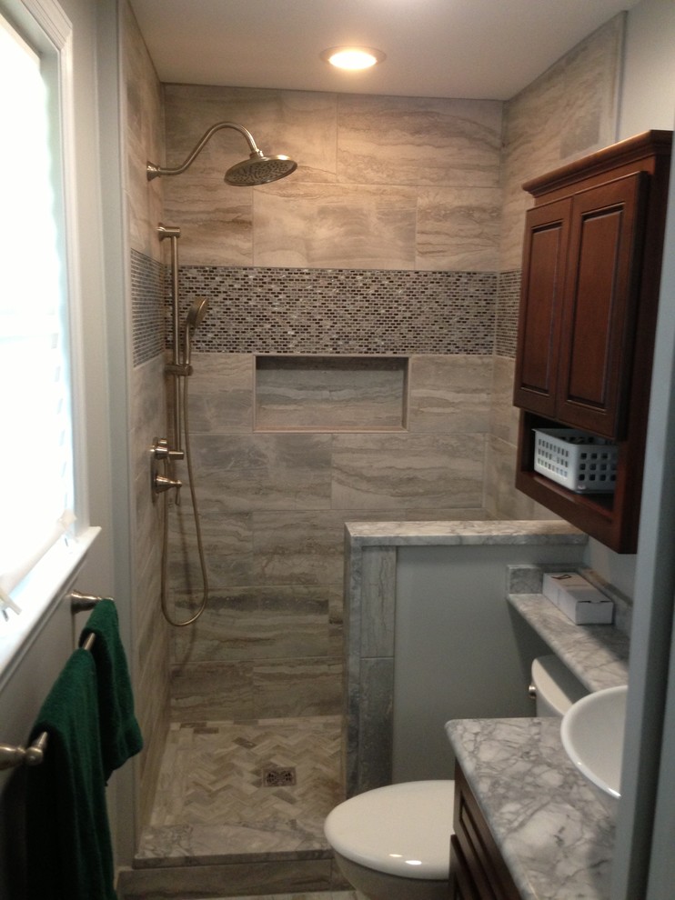 Small transitional 3/4 gray tile, white tile and porcelain tile porcelain tile doorless shower photo in Baltimore with raised-panel cabinets, dark wood cabinets, a two-piece toilet, white walls, a vessel sink and quartzite countertops